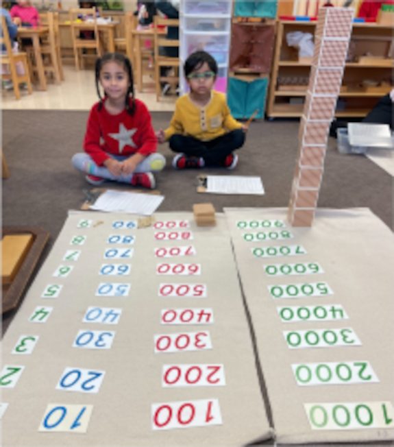 two primary aged girls working with numbers